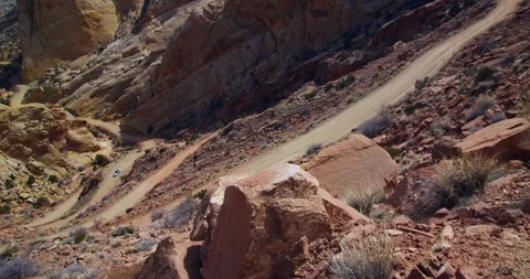 SUV descending  Burr Trail Switchbacks into the colorful Strike Valley, Utah. Stock Footage 124074995