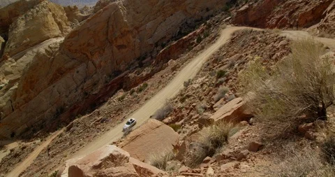 SUV descending Burr Trail Switchbacks into the colorful Strike Valley, Utah. Stock Footage 124100048