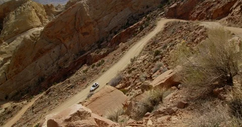 SUV descending Burr Trail Switchbacks into the colorful Strike Valley, Utah. Stock Footage 124101485