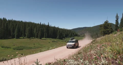 SUV Drive-By on Dirt Mountain Road | Colorado Stock Footage
