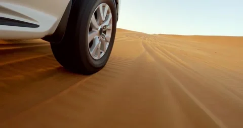 SUV drive with wheel rotating over desert sand dunes in sunny weather landsca Stock-Footage 296843484
