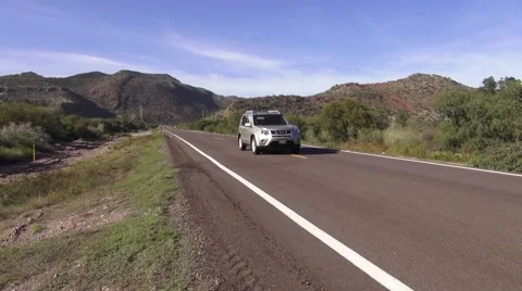 SUV Drives By On Baja Highway Stock Footage 51849014