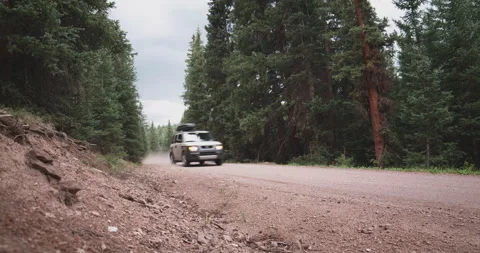 SUV Drives Fast Down Dirt Mountain Road Stock Footage 152784491
