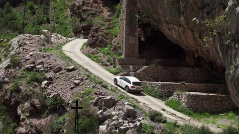 The SUV drives up the mountain along the mountain road Stock Footage 196126307