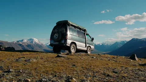SUV drives off-road against the background of a epic mountain landscape Stock Footage 140901176