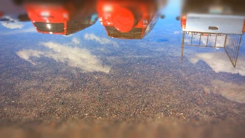 SUV drives through reflective puddle of water Stock Footage 88629311