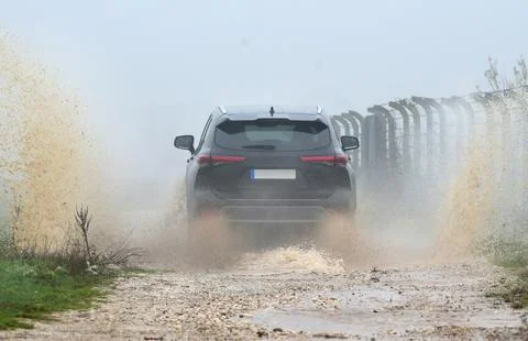 Suv drives through water Stock Photos