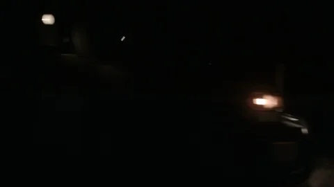 Suv driving down dark dirt road with car following Stock Footage 90442531