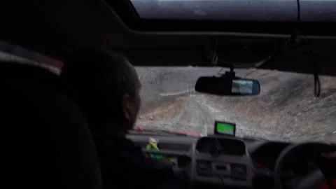 The SUV is driving fast down the slope with a lot of shaking. View from the car Stock-Footage 266887070