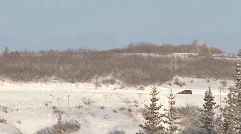 SUV Driving Left to Right on Snowy Road Stock Footage 10575241