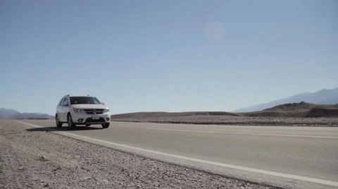 SUV driving past in desert 動画素材 56326658