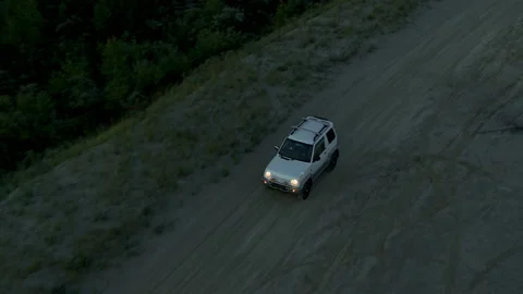 The SUV is driving on the road at dawn Stock Footage 180907178