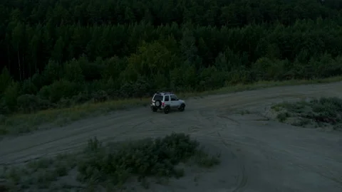 The SUV is driving on the road at dawn Stock Footage 194148535