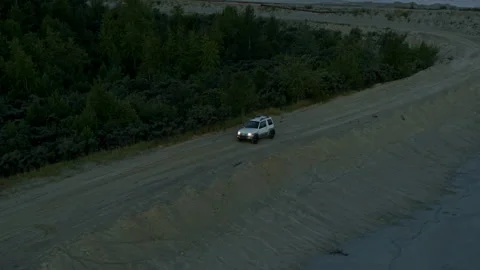 The SUV is driving on the road at dawn Stock Footage 194150953