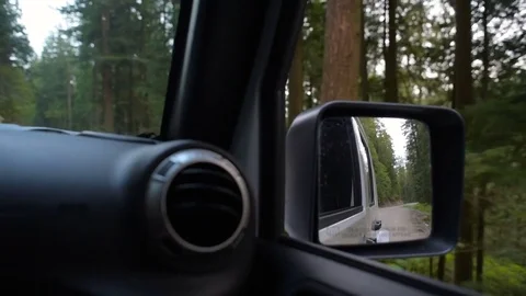 SUV driving through forest in mountains Vidéo 82444301