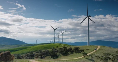 SUV driving through wind farm in southern Australia. Stock Footage 98844868
