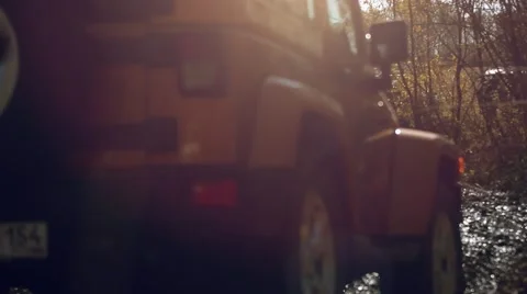 SUV got stuck in the mud and trying to go out in the autumn forest Stock Footage 52546758