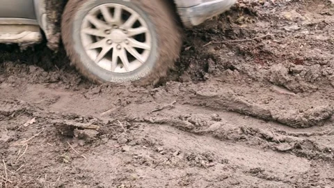An SUV with Hankook tires skids through the mud in the courtyard of a house Stock Footage 260749459