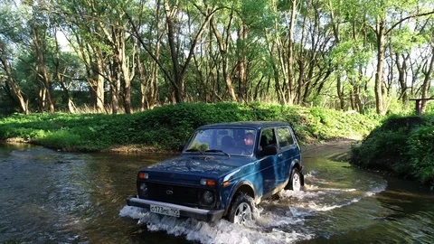 SUV Lada Niva in river Stock Footage 91385422