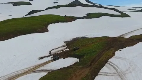 SUV on large wheels rides in peas in the snow in Kamchatka High quality HD Stock Footage 142390518
