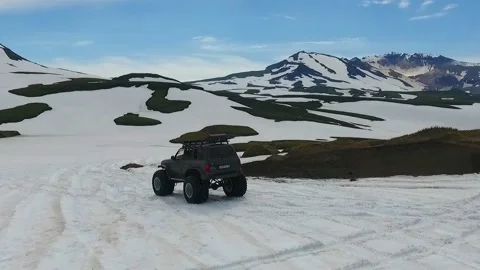 SUV on large wheels rides in peas in the snow in Kamchatka High quality HD Stock Footage 142390767