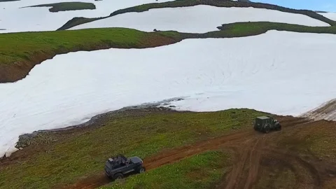 SUV on large wheels rides in peas in the snow in Kamchatka High quality HD Stock Footage 142390947