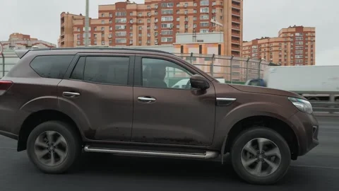 SUV Oting Paladin driving along a country highway. autumn, cloudy 스톡 동영상 320347797