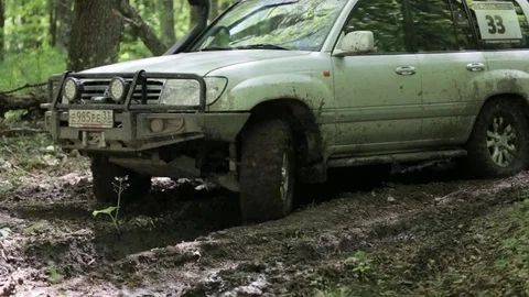 SUV overcome difficult dirty section offroad in 4x4 expedition Stock Footage 75846861