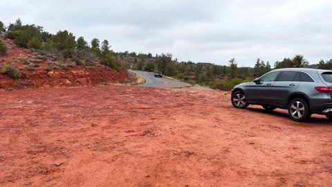 SUV Parked as Another Drives on Red Dirt Path Stock Footage 276192793