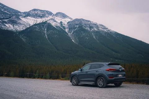 SUV parked with mountains in the background Stock Photos