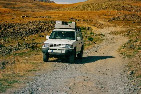 Suv on a paved platform in mountains. Stock Photos