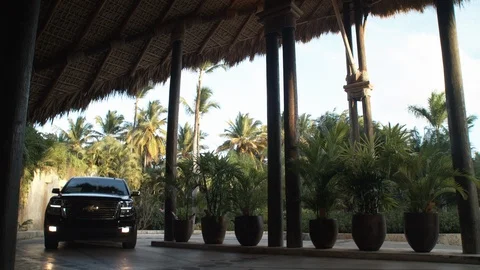 SUV pulls up to Caribbean retreat Stock Footage 113392088