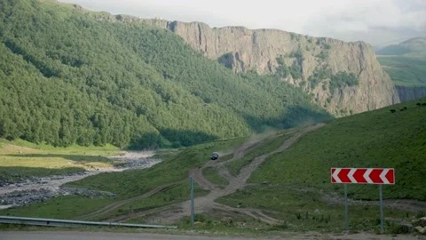SUV rides on a mountain road in the Caucasus Stock Footage 136436971