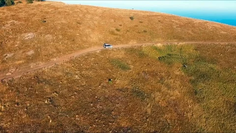 SUV rides through the mountains Stock Footage 89089909