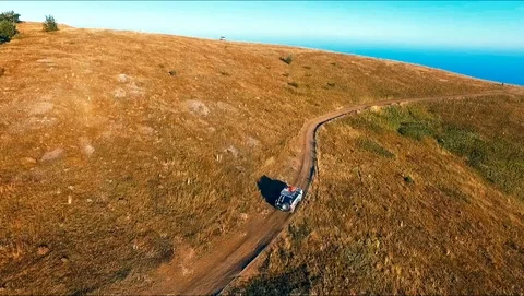 SUV rides through the mountains Stock Footage 89091517