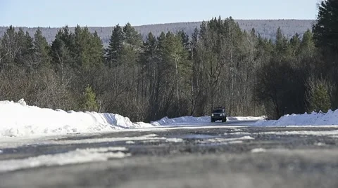 SUV rides on winter road through the forest Stock Footage 64466480