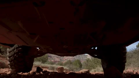 SUV slowly passes over camera on dirt road Stock Footage 253639611