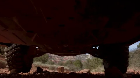 SUV slowly passes over camera on dirt road Stock Footage 254769060