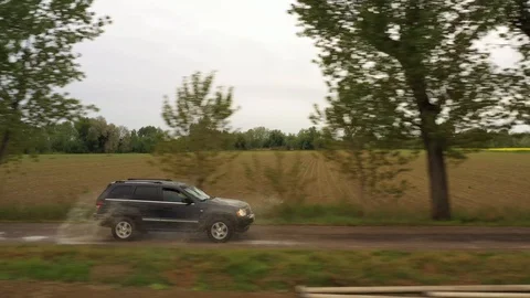 Suv on a tree-lined path. Suv su sentiero alberato. Stock Footage 129079077