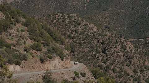 SUV on Winding Mountain Road Along Steep Slope in Atlas Mountains Morocco Stock Footage 340220286
