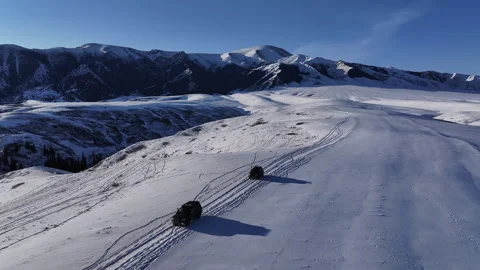 Suvs driving off-road through deep snow in a mountain range Stock Footage 321735029