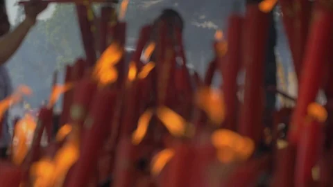 Suzhou, China - October 10, 2018: Blured close-up of burning candles in buddhist Stock Footage 100559341