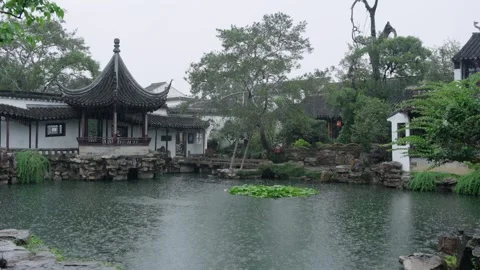 Suzhou Classical Chinese Garden in Rain, Pavilion over Pond with Rockery Stock Footage 345221292