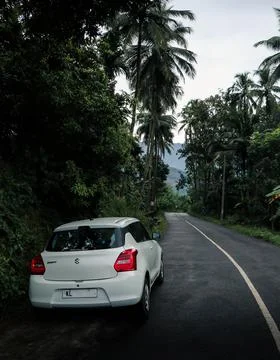 Suzuki Swift parked roadside while touring in Kerala, India on 25th November Stock Photos