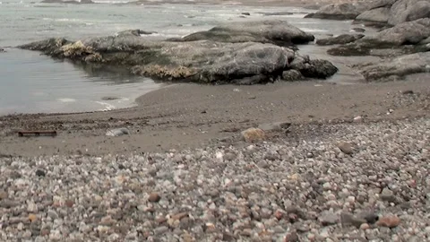 Svalbard's Rugged Arctic Shore Calm Waters Meet Ancient Rocks Stock Footage 340484777
