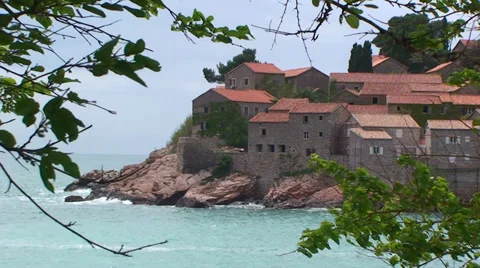 Sveti Stefan framed by tree branches Stock Footage 33354988