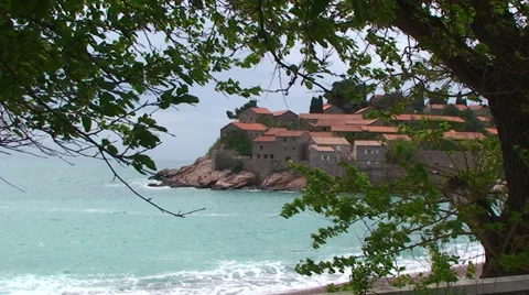 Sveti Stefan framed by tree branches Stock Footage 33355161