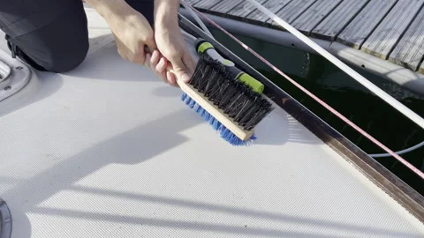 Swabbing the Deck Boat Cleaning with Brush on Dock marine vessels Stock Footage 278282978