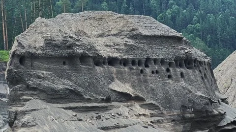 Swallows fly to their nests in the rock. Slow motion video. 動画素材 306451765