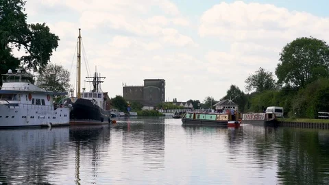 Swan and barge on the Sharpness - Gloucester Canal at Saul Junction Stock Footage 114647389